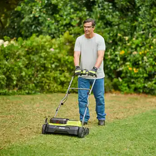Man scarifying grass
