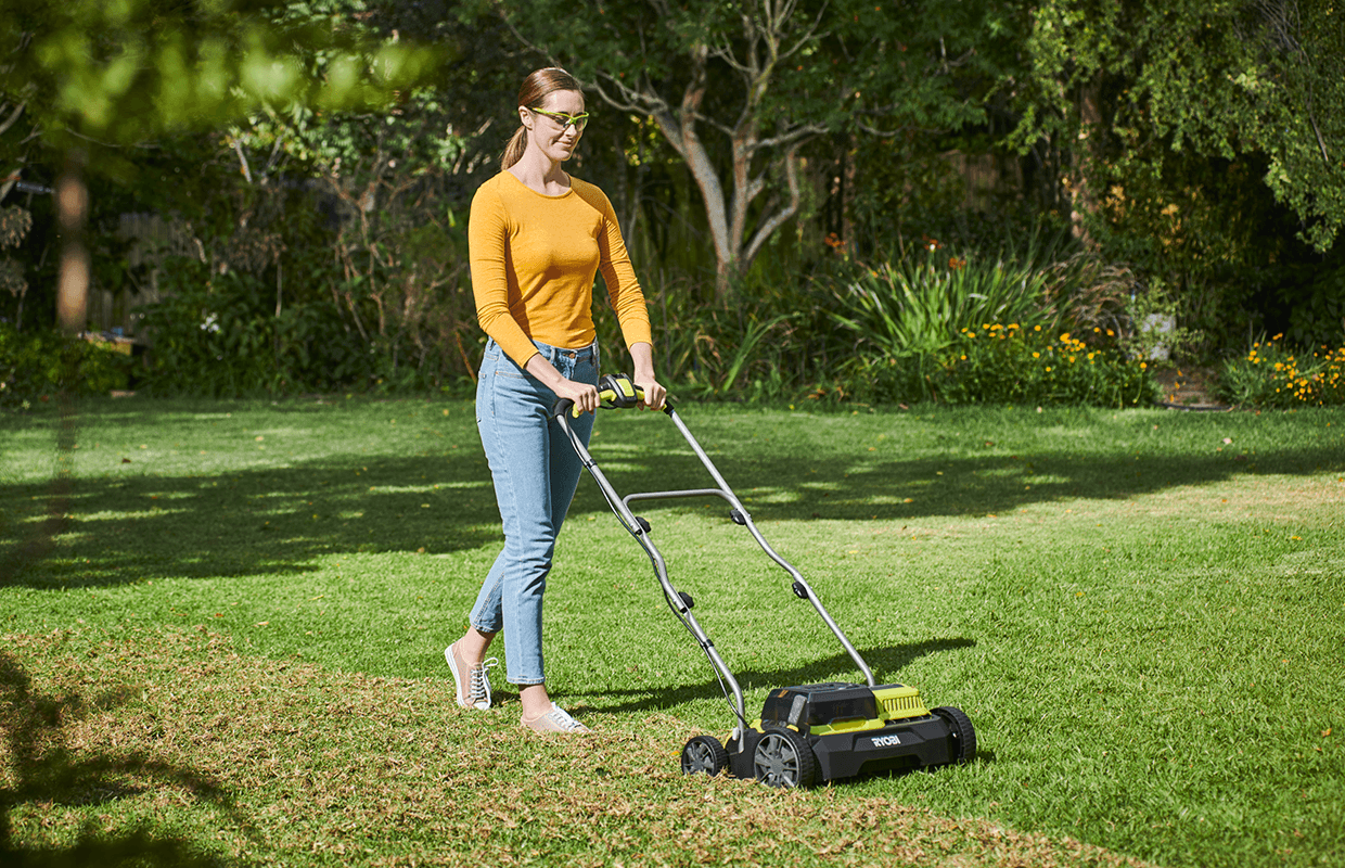 Woman mowing grass